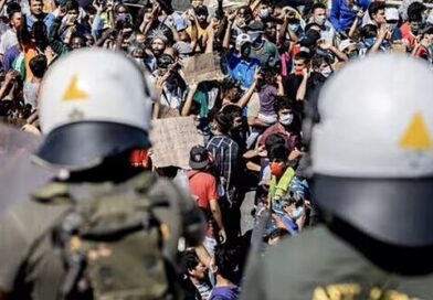 Migrants throw stones and brawl with police during 'riot'